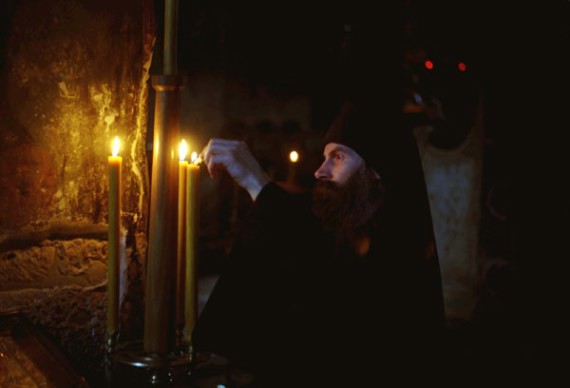 Lighting a candle, Visoki Decani Monastery monk, Serbia