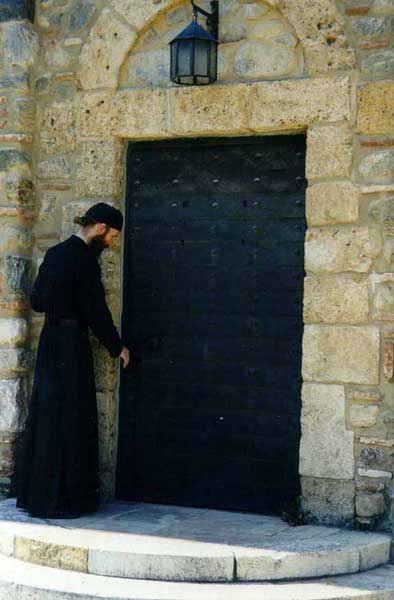 At the door of the old refectory, Visoki Decani Monastery monk, Serbia