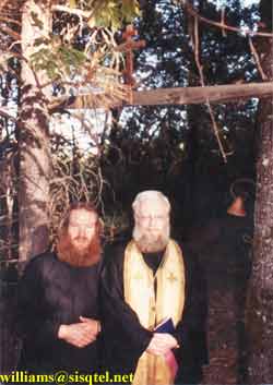 Fr. Deacon Lawrence and Fr. Alexey Young standing at the gateway to Blessed Seraphim's cell - Copyright  The Blessed Seraphim Hermitage