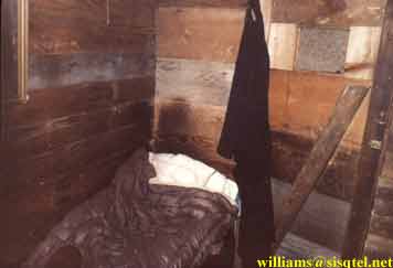 His bed and the door to his cell. On may observe the stains on the wall where he laid his head - Copyright  The Blessed Seraphim Hermitage