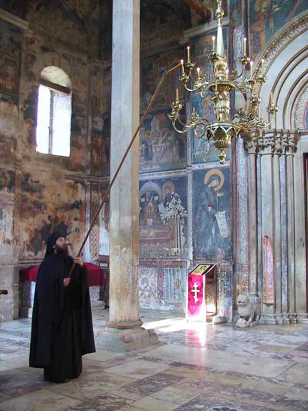 Lighting the chandelier, Visoki Decani Monastery monk, Serbia