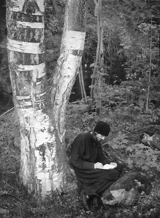 Russian monk taking notes