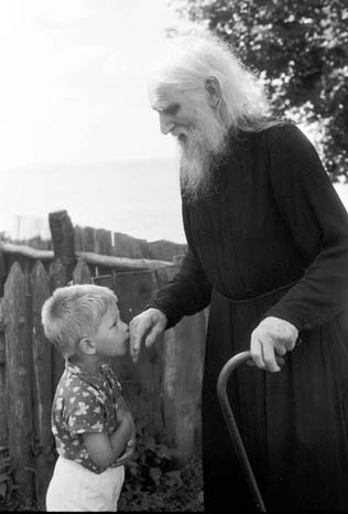 Child kissing a father's hand